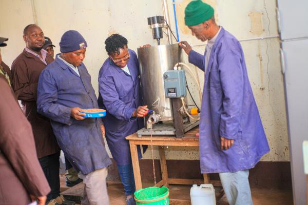 EC CHINA: training extract tannins from tree bark Black female scientist delivering training