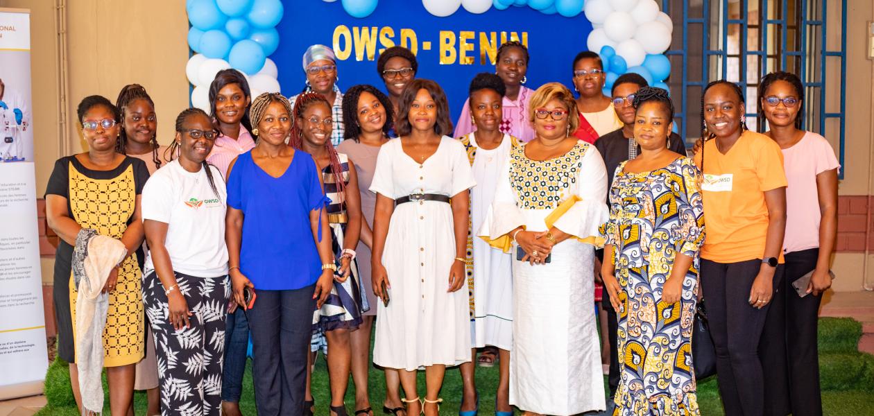Women gather on stage for a picture at an event