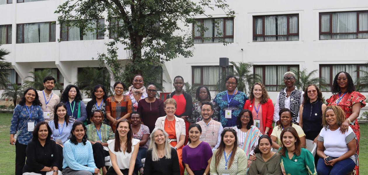 A group of women scientists pose for group photo holding certificates