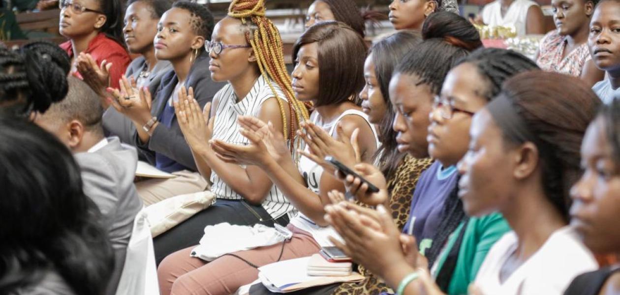 Women in an audience clapping